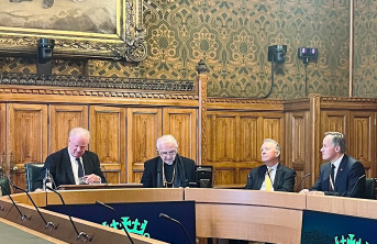 Four men sitting round a table in Parliament