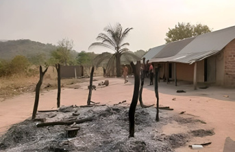Burnt patch of ground with burnt wooden supports