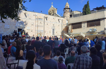 People gathered in a square in front of a church.