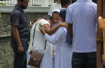 Sisters consolling woman after attacks in Sri Lanka