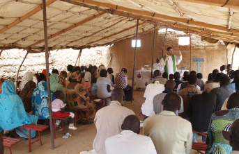 Priest with his community in Sudan